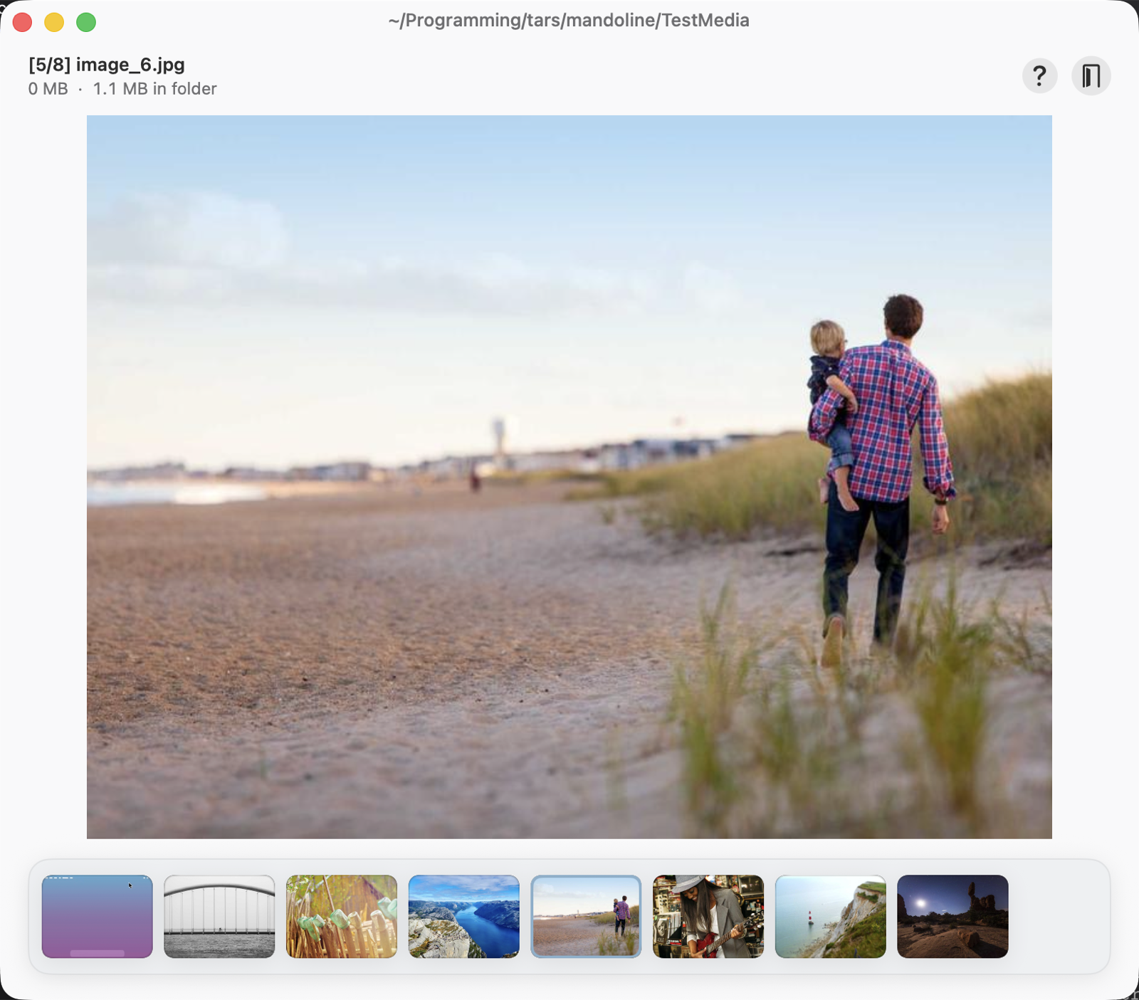 The Mandoline app reviewing a photo: the folder path in the title bar, a file counter with size readout, a large media preview, and a thumbnail carousel along the bottom